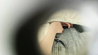 College Student Peeping Through a Hole